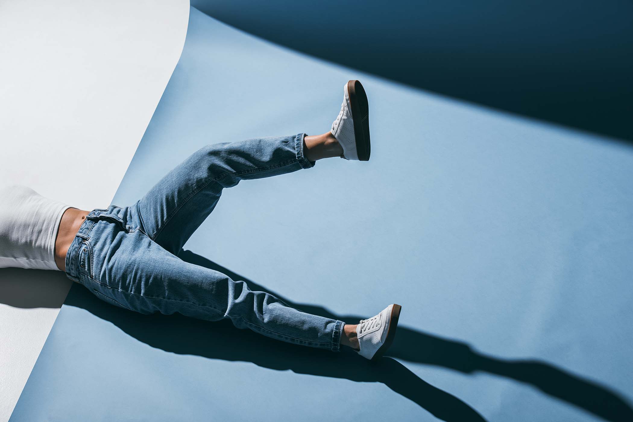 cropped-image-of-stylish-girl-lying-on-floor-in-je-3BVQHM6.jpg